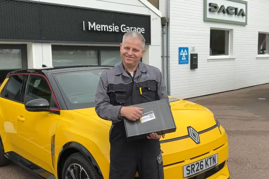 John Buchan of Memsie Garage holding a Mussay handover pack next to a new Renault 5