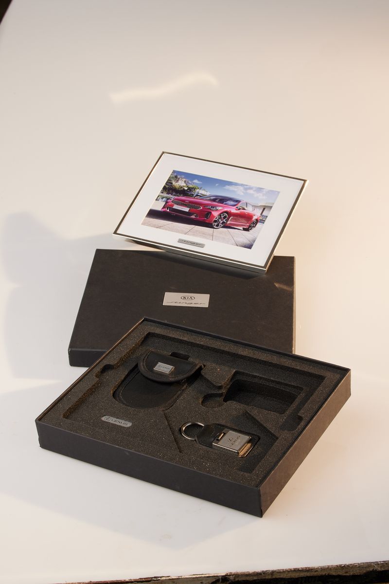 Branded Silverstone box open beneath its lid and framed photo